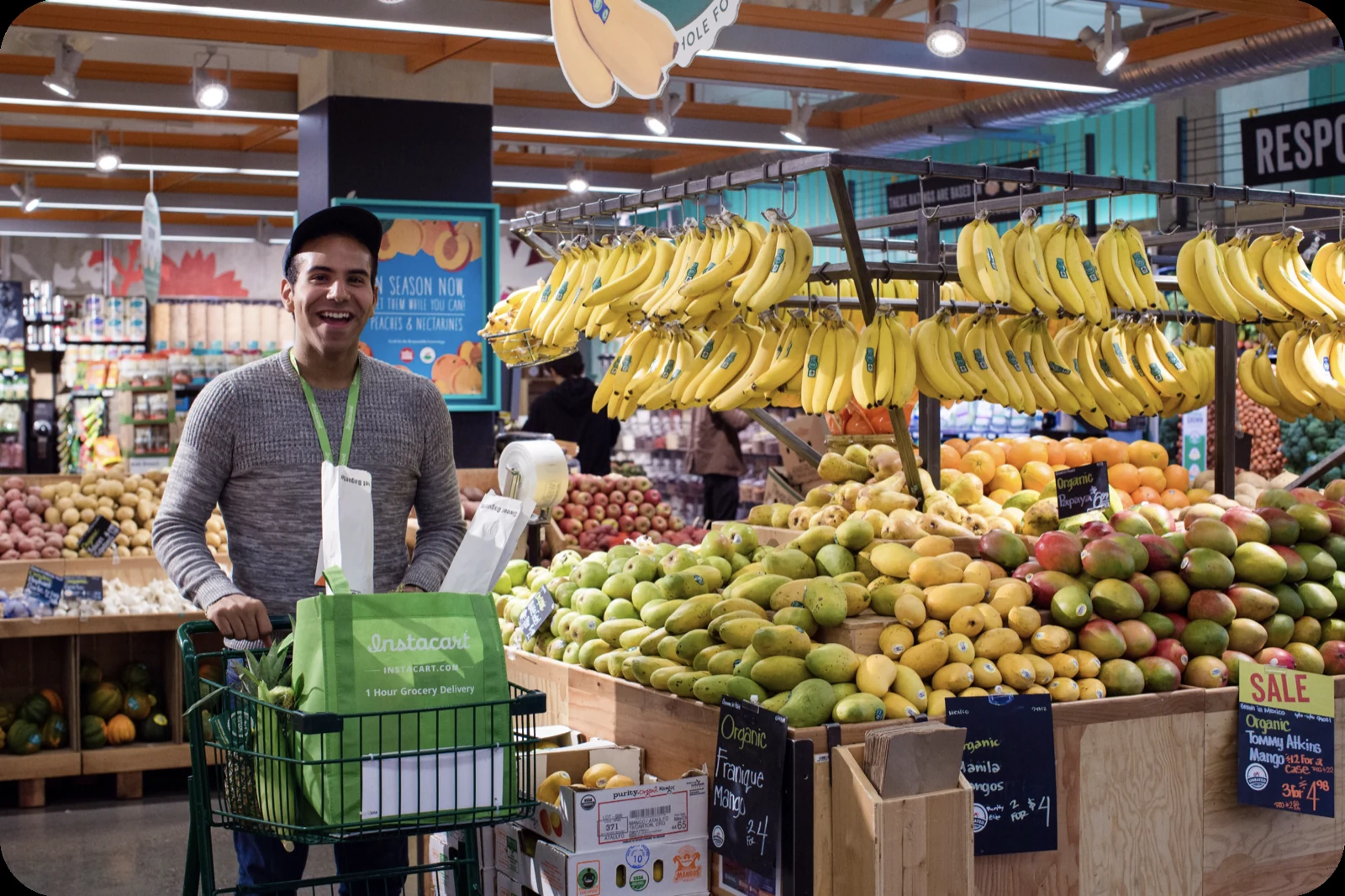 An Instacart shopper selecting produce in a grocery store